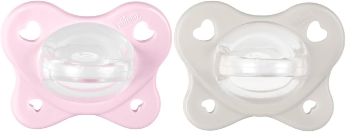 Dwa smoczki Chicco PhysioForma Dual Soft, różowy i szary, z przezroczystymi końcówkami.
